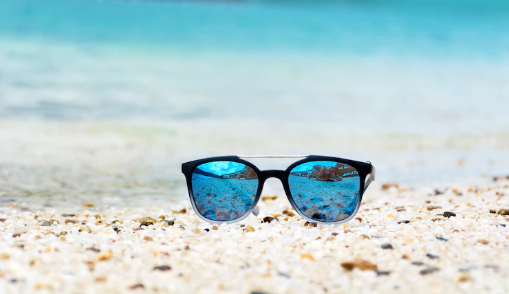 blue sunglass in sand